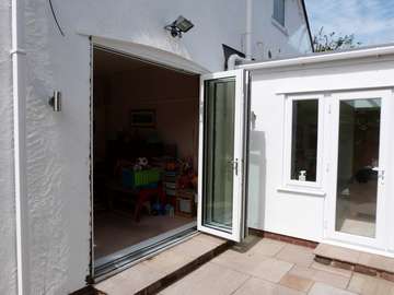 DAVENHAM , CHESHIRE : New Hybrid PvcU /Alumnium Bi Folding doors. Double glazed with 28mm "A" rated units. The doors come with a Flush floor track. 135mm slimline profile.